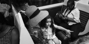 A peaceful family sitting together on a modern, clean train carriage.