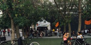 A peaceful, vibrant neighborhood micro-festival scene in a local park.