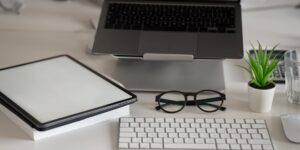 A desk setup showing the bridge between physical and digital family photo archives.