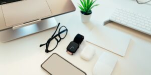 A clean, organized desk with various pre-owned electronic devices being prepared for use.