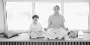A parent practicing calm breathing in a serene home setting.