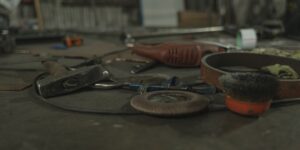A well-organized community tool library with various DIY and gardening equipment on wooden shelves.