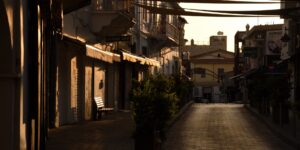 A quiet, empty historic street at sunrise representing the off-peak travel philosophy.