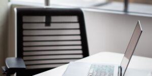 A modern mesh router in a clean home office setting.