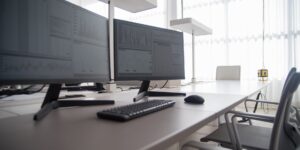 A professional desk setup with high-end refurbished technology.