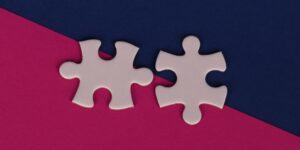 Two puzzle pieces fitting together representing cooperative parenting