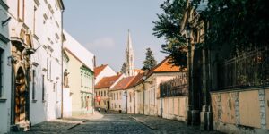 A quiet, historic street at golden hour representing off-peak travel.