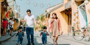 A parent and child exploring local history on a neighborhood street at sunset.
