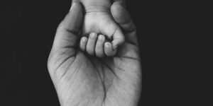 A minimalist illustration representing parent and child emotional connection.