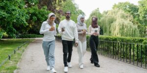 A diverse community gathering in a modern urban park setting.