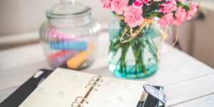 A glass jar filled with colorful notes on a desk representing emotional vocabulary tools.