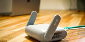 A professional home office setup featuring a modern mesh WiFi node.