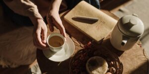 A peaceful morning scene showing a notebook and tea, representing the start of a restorative break.