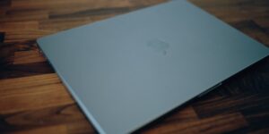A closed laptop on a desk representing the end of the workday.
