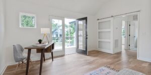 A bright, modern home office space with a balcony view, representing the work-from-anywhere lifestyle.