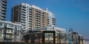 Modern micro-community housing complex with shared outdoor spaces at twilight.