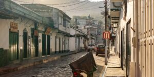 A quiet, historic street during the golden hour, representing the calm of off-peak travel.