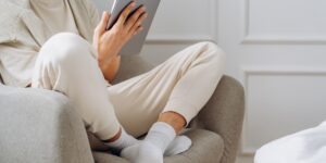 A person performing a home energy audit with a tablet and thermal tool.