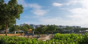 A modern residential community with shared green spaces and families enjoying the outdoors.