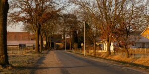 A quiet, peaceful European village square during the golden hour, perfect for off-peak travel.