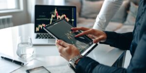 A professional analyzing financial growth on a laptop in a home office.