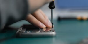 A close-up of a person repairing a smartphone, representing the Right to Repair movement.
