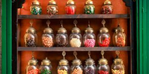 A glass jar filled with colorful emotional vocabulary slips on a wooden table.