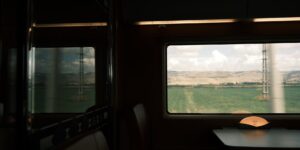 A scenic view from a train window during a slow-travel journey.