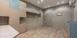 Modern home living room with an integrated wooden climbing wall for children and adults.