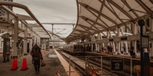 A modern train station scene representing weekend travel planning.