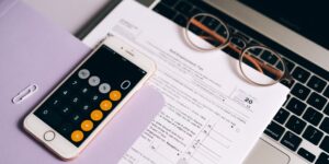 Modern home office workspace with laptop and calculator