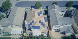 Modern home with solar panels and a wall-mounted battery storage system.