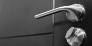 A modern smart lock installed on a sleek apartment door.