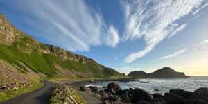 A modern train winding along a scenic coastal cliffside, representing the joy of rail travel.