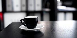 A quiet, minimalist workspace with a coffee cup, symbolizing the start of a restorative break.
