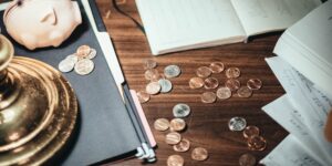 A minimalist setup of a savings jar and notebook for teaching children financial responsibility.