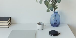 A clean home office setup featuring a mesh Wi-Fi node.