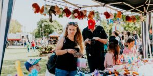 Families enjoying a small, community-focused micro-festival in a local park.