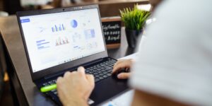 A clean, modern workspace featuring a laptop with financial data, representing the 2026 wage and inflation tracker.