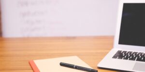 A laptop and notebook on a desk representing a professional taking a planned break.
