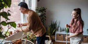 A couple peacefully organizing household tasks together in a modern home setting.