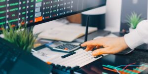 Modern home office setup with financial dashboard on laptop