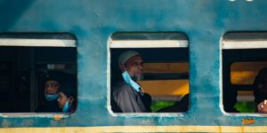 A family enjoying the view from a train window during a vacation.