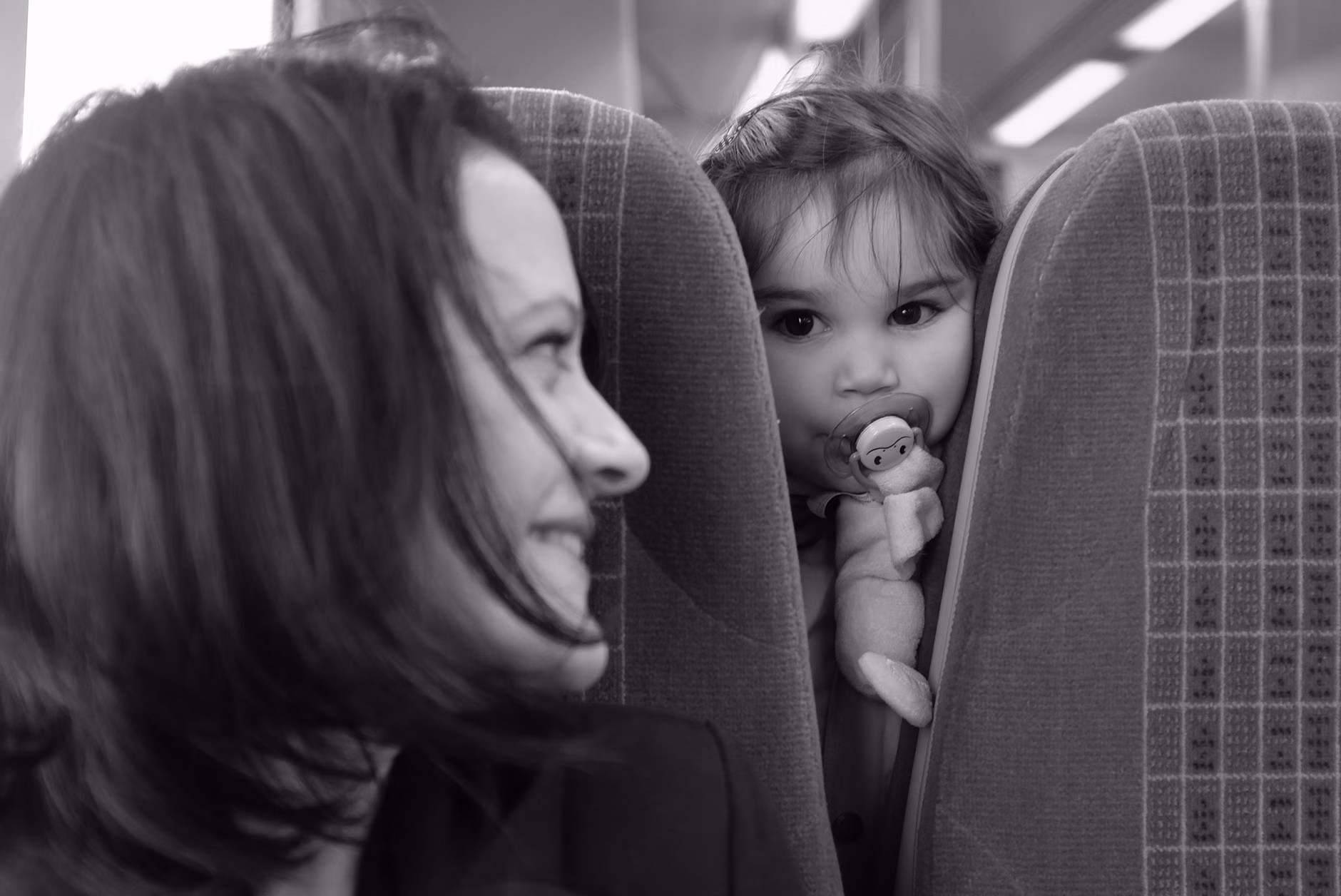A parent and child preparing for a train journey.