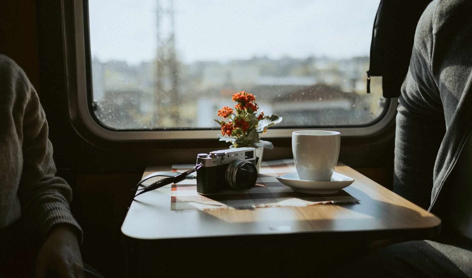 Digital train ticket and coffee on a train tray table.