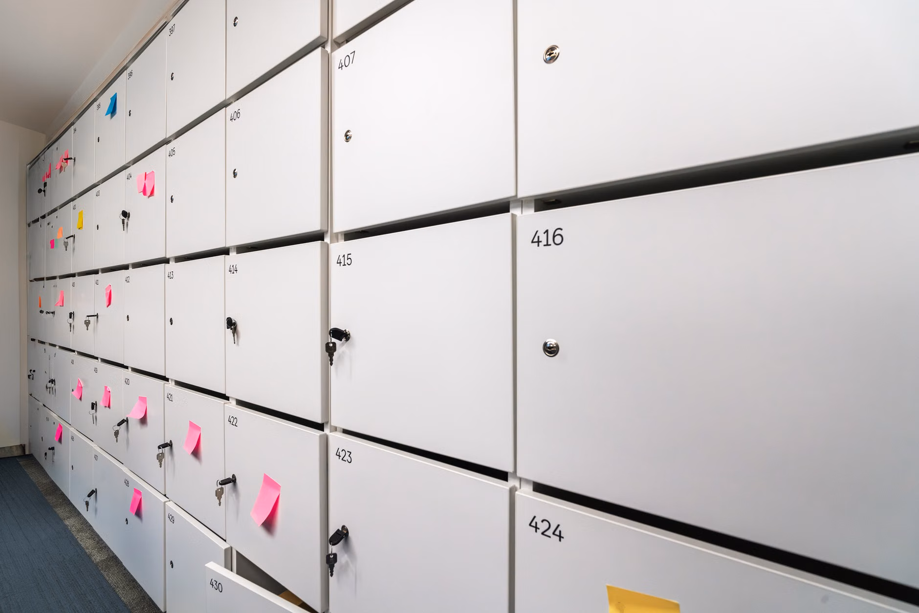 Minimalist storage cabinet hiding office supplies in a multi-purpose room.
