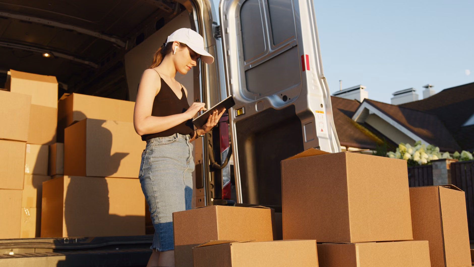 A person using a tablet to monitor global logistics and supply chain status.
