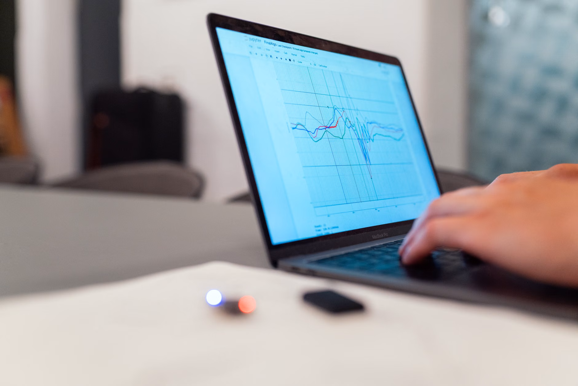 Analyzing energy consumption data on a laptop screen.