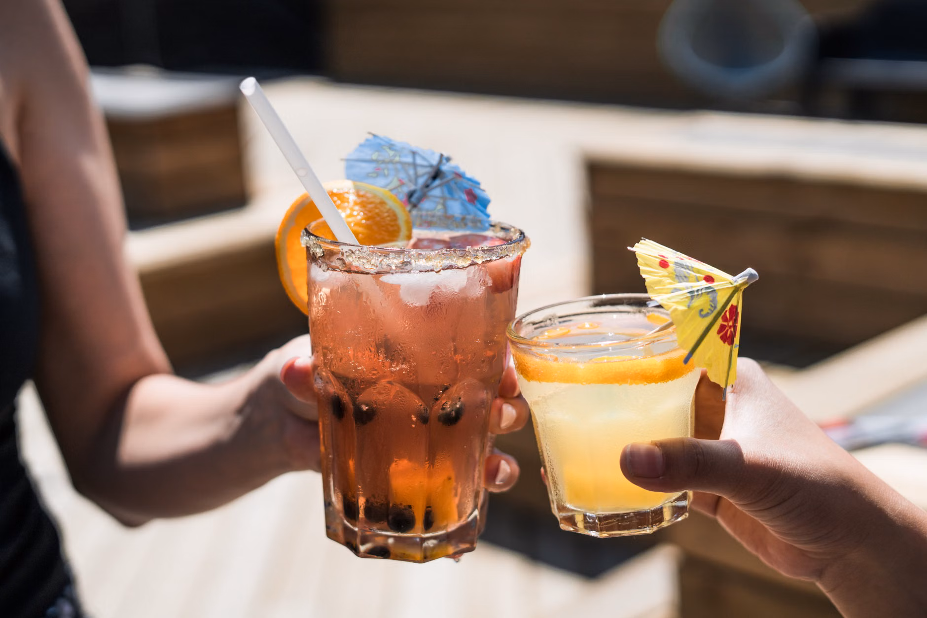 Socializing with a non-alcoholic botanical drink in hand.