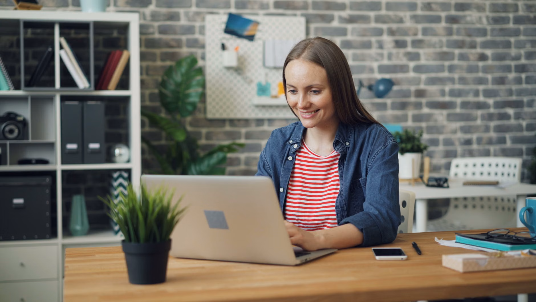 A professional working in a bright home office on a laptop.